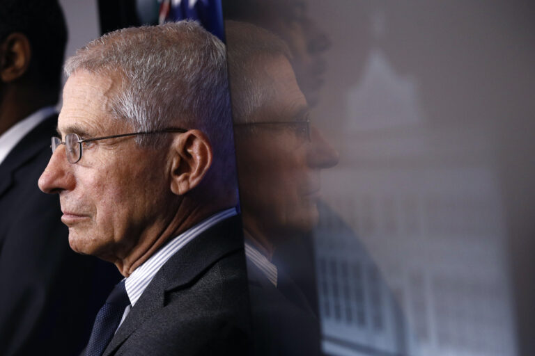 In this March 21, 2020 file photo, Director of the National Institute of Allergy and Infectious Diseases Dr. Anthony Fauci listens as President Donald Trump speaks during a coronavirus task force briefing at the White House in Washington. (AP Photo/Patrick Semansky)