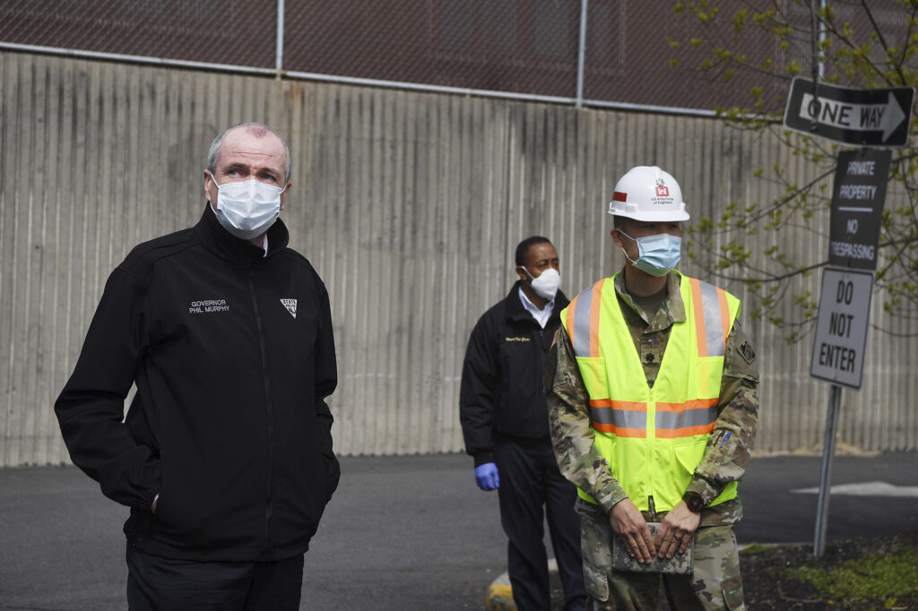 New Jersey Gov. Phil Murphy, left, visits an alternate care facility at East Orange Hospital in East Orange, N.J., amid the coronavirus pandemic, on Wednesday, April 22, 2020. (Michael Karas/The Record via AP, Pool)