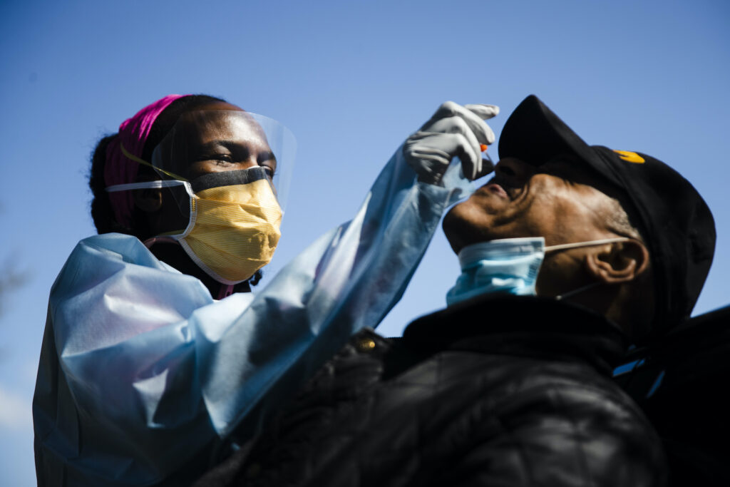 APTOPIX Virus Outbreak Pennsylvania Daily Life Dr. Ala Stanford administers a COVID-19 swab test on Wade Jeffries in the parking lot of Pinn Memorial Baptist Church in Philadelphia, Wednesday, April 22, 2020. (AP Photo/Matt Rourke)