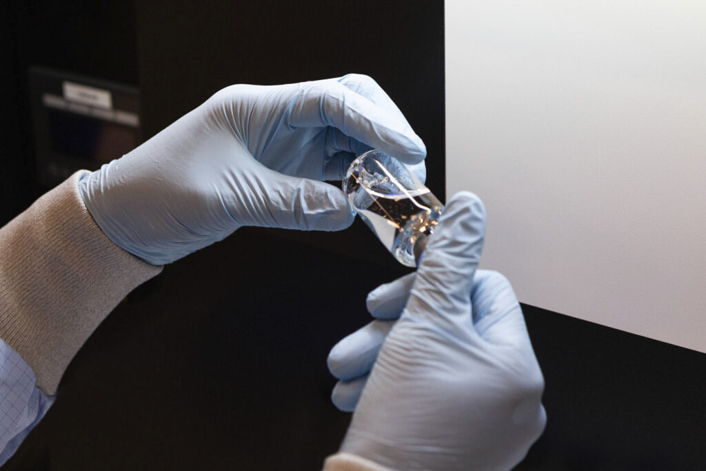 Virus Outbreak Treatment In this March 2020 photo provided by Gilead Sciences, a vial of the investigational drug remdesivir is visually inspected at a Gilead manufacturing site in the United States. (Gilead Sciences via AP)
