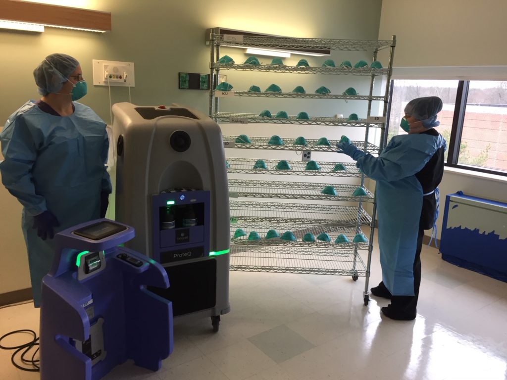 IMG_2347 Doylestown Health workers place used N95 masks on a rack for HPV sanitation. (Courtesy of Ron Watson/Doylestown Health)