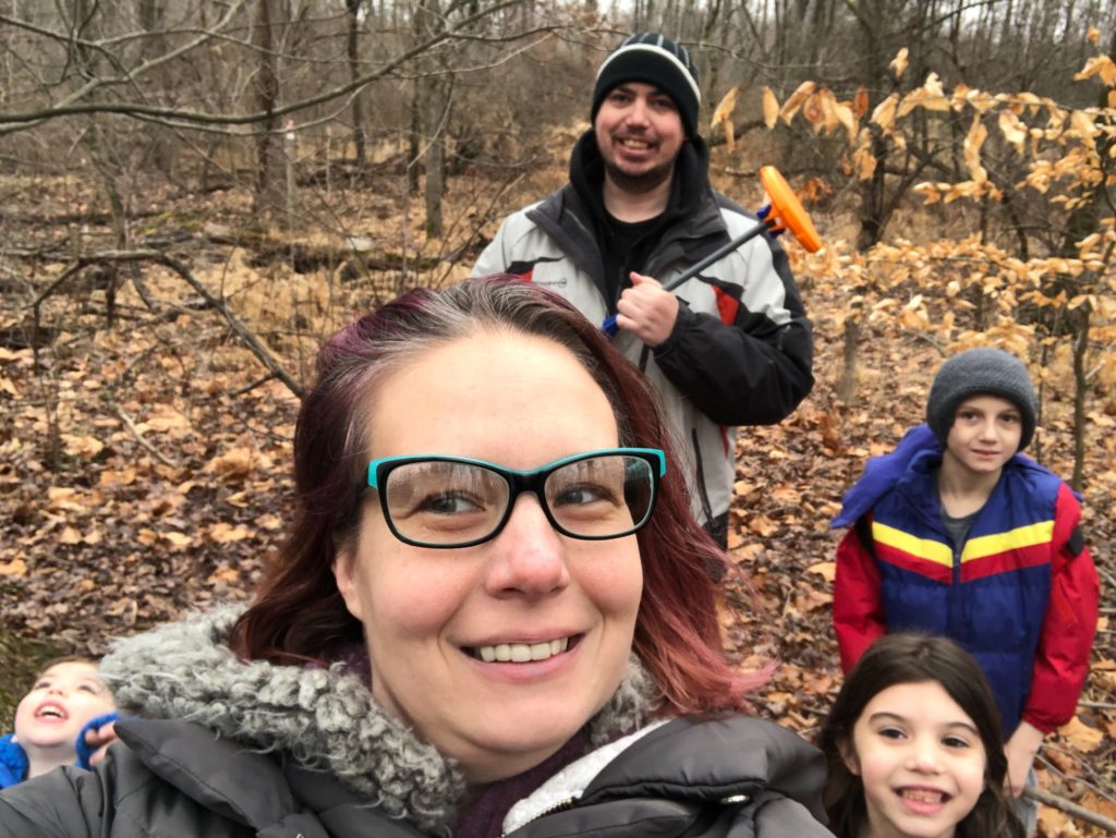 Sites family Dawn Sites with her family in the woods behind her house. Her son Jaiden wears a blue, red and yellow jacket. (Courtesy of Dawn Sites)