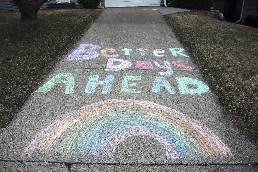 Virus Outbreak Minnesota A chalk message and rainbow adorn a driveway with a positive message in the fight against the coronavirus at a home on Wednesday, April 1, 2020. (AP Photo/Jim Mone)