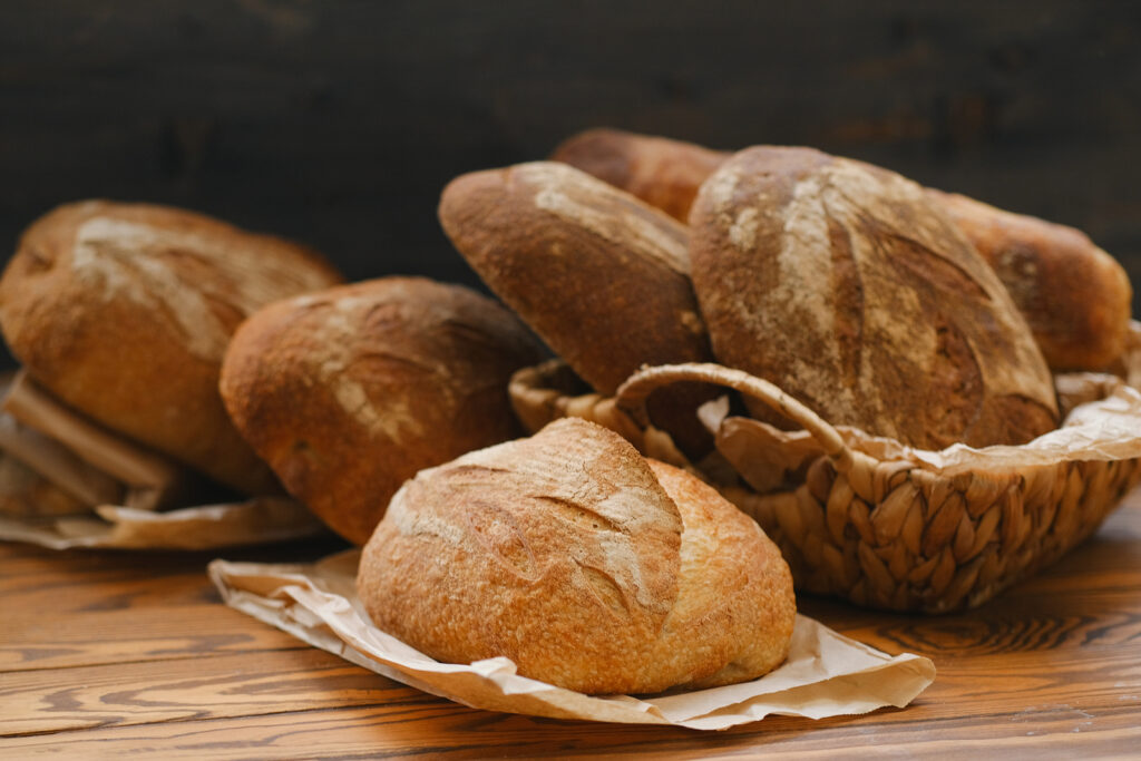 Different Buns Of Fresh Bread On A Brown Vintage Background. Fre Baking Bread