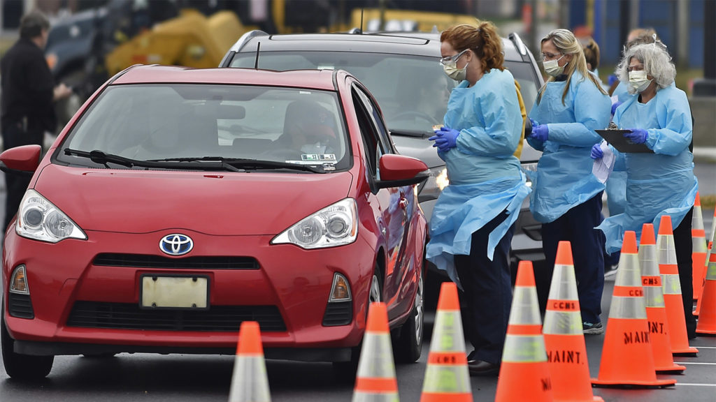 Drive-through test sites like this one in Delaware are popping up around the Philly region. (Butch Comegys for WHYY)