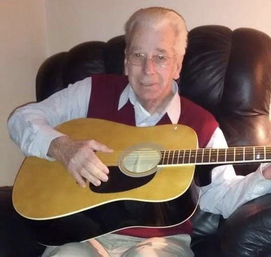dad with guitar Charlie Secrest, pictured about six years ago, died at a Delaware nursing home on April 6 after contracting coronavirus. (Courtesy of Terri Hansen)
