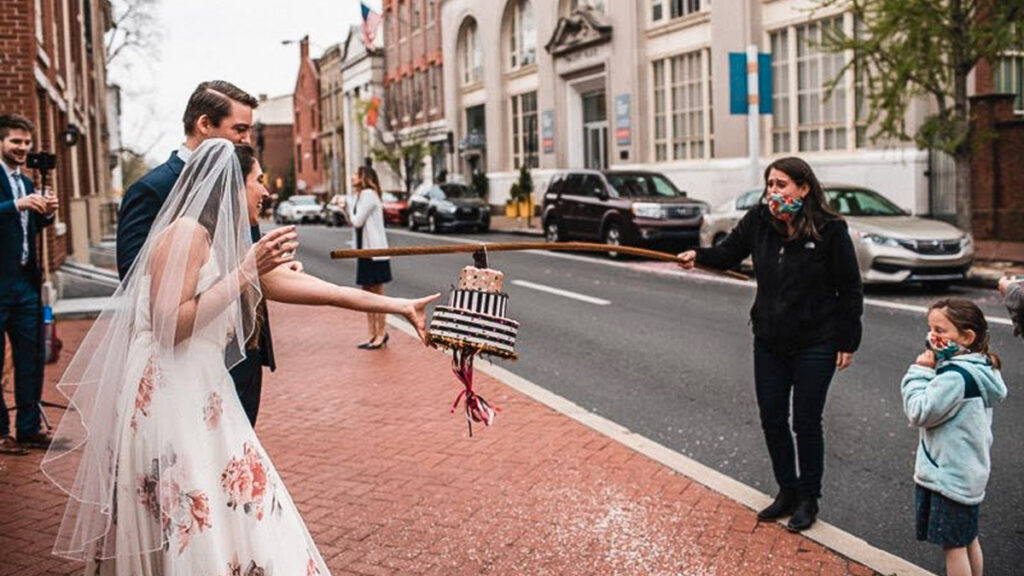 jessadam-pandemicwedding-02crop Jessica Heaven and Adam Kasprak getting a 'cake' from a friend at their April 17 wedding. (Joel Todero/Courtesy of Jessica Heaven and Adam Kasprak)