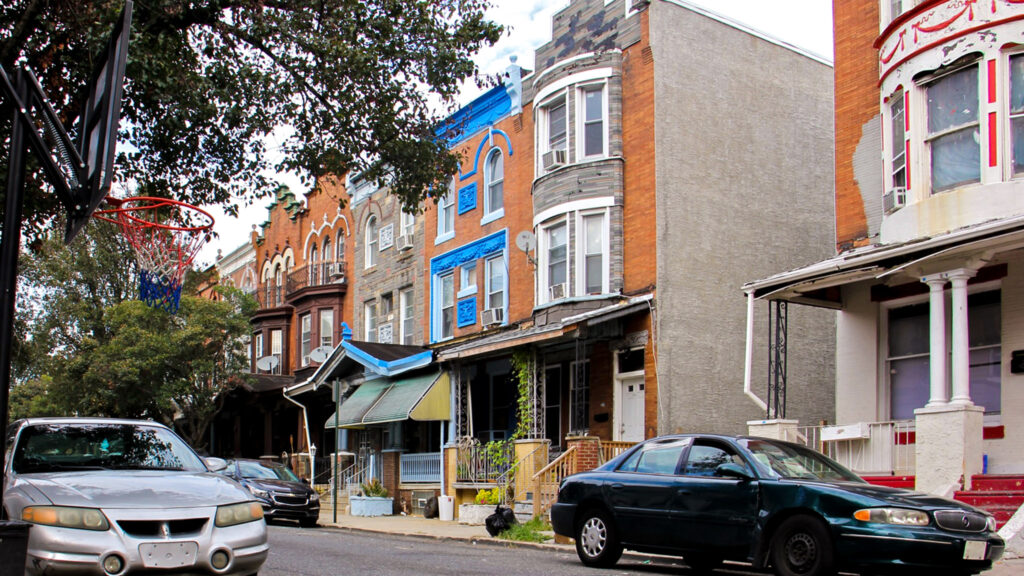 Some homes in the 3700 block of North 15th Street, where six Philadelphia police officers were wounded during a shoot out in August, still have the bullet holes. (Emma Lee/WHYY)