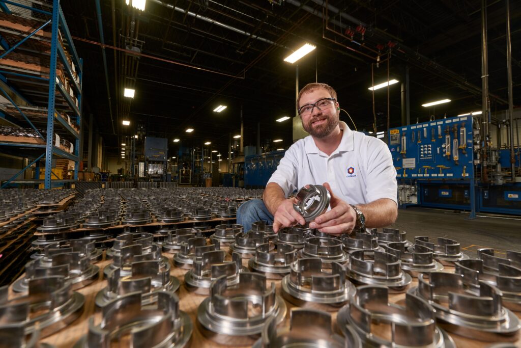 plant manager Plant manager Joe Glass poses with automotive parts manufactured by Catalus Corp. (Photo provided by Dave Parsons)