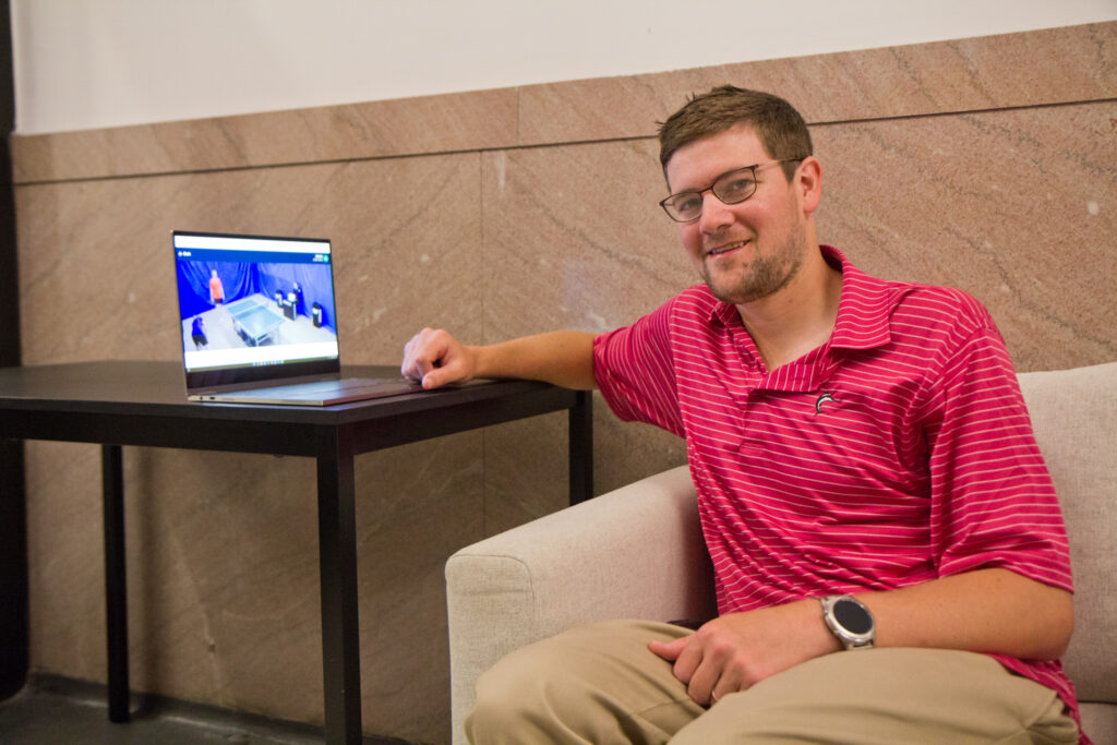 Matthew Nelson watches Russian table tennis in the lobby of his apartment building after placing a bet. (Kimberly Paynter/WHYY)