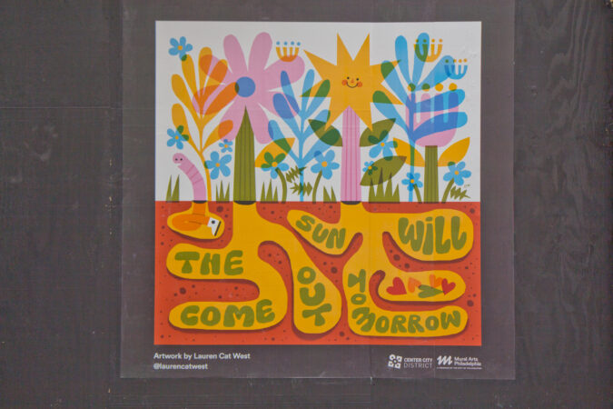 The Mural Arts Program installed works on storefronts boarded up due to coronavirus lockdowns in Center City. This work on Chestnut Street is by artist Lauren Cat West. (Kimberly Paynter/WHYY)