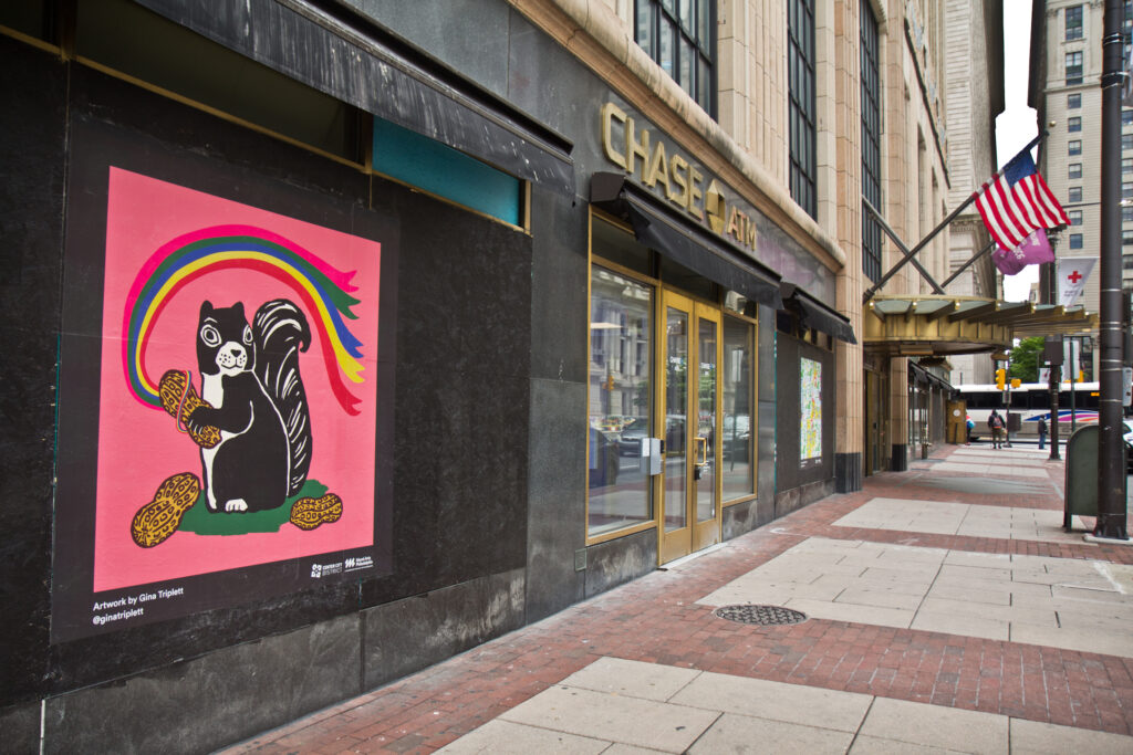 2020 5 12 8 k paynter storefront murals The Mural Arts Program installed works on storefronts boarded up due to coronavirus lockdowns in Center City. This cheerful squirrel across from City Hall is by artist Gina Triplett. (Kimberly Paynter/WHYY)