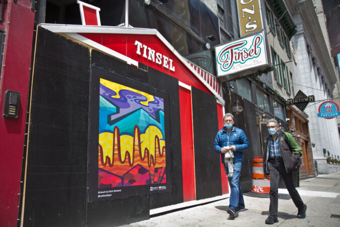 The Mural Arts Program installed works on storefronts boarded up due to coronavirus lockdowns in Center City. This abstract piece on 12th Street is by artist Darin Roland. (Kimberly Paynter/WHYY)