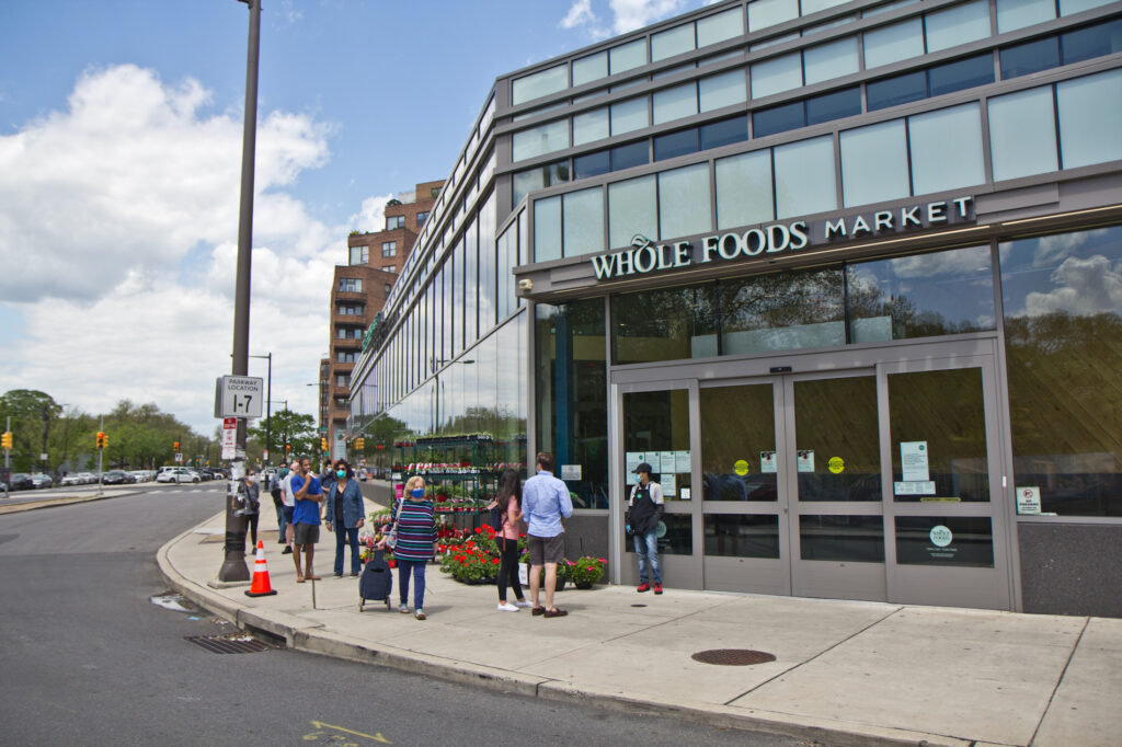 2020 5 4 k paynter whole foods-4 An employee directs people into the store at the Whole Foods grocery in Philadelphia’s Fairmount neighborhood. (Kimberly Paynter/WHYY)