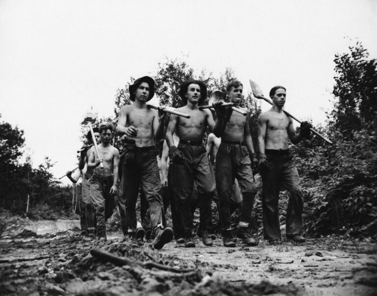 A crew of the Civilian Conservation Camps, which was started in 1933, has taken young men off the bread lines during the depression and put thousands to work.  These men, seen in 1940, were at the CCC's Camp Tomahawk in Wisconsin,. They helped fight forest fires by building fire lanes, clearing brush and the lake.  (AP Photo)