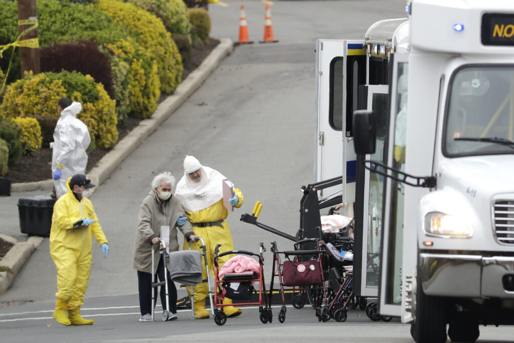 Virus Outbreak New Jersey Residents from St. Joseph's Senior Home are helped on to buses in Woodbridge