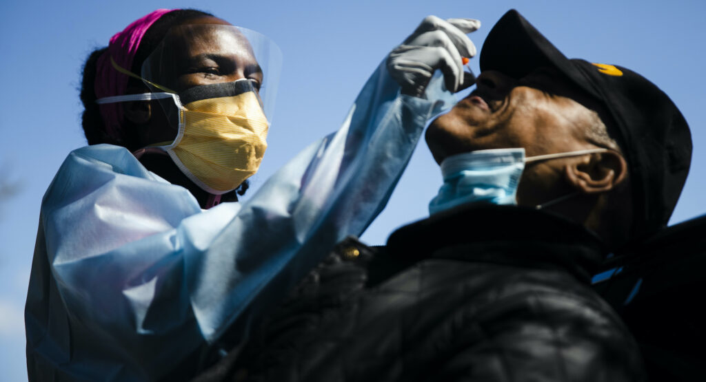 APTOPIX Virus Outbreak Pennsylvania Daily Life Dr. Ala Stanford administers a COVID-19 swab test on Wade Jeffries in the parking lot of Pinn Memorial Baptist Church in Philadelphia, Wednesday, April 22, 2020. Stanford and other doctors formed the Black Doctors COVID-19 Consortium to offer testing and help address heath disparities in the African American community. (AP Photo/Matt Rourke)