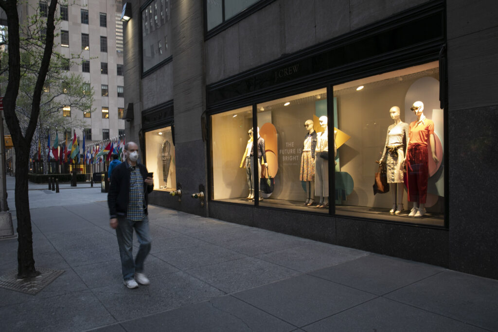 Virus Outbreak New York J Crew A man wearing a mask walks by a window display at a J Crew store in Rockefeller Center, Saturday, May 2, 2020, in New York. On April 30, the company announced it would apply for bankruptcy protection amidst the COVID-19 pandemic. (AP Photo/Mark Lennihan)