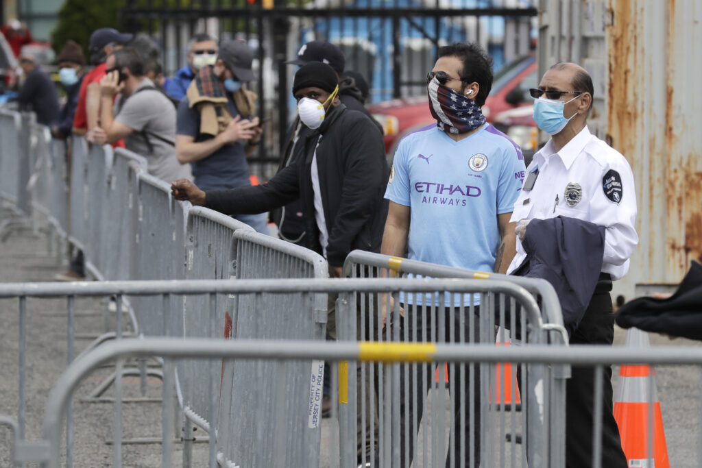 Virus Outbreak New Jersey People wait in line to be tested for the new coronavirus at a testing site in Jersey City, N.J., Monday, May 4, 2020. (AP Photo/Seth Wenig)