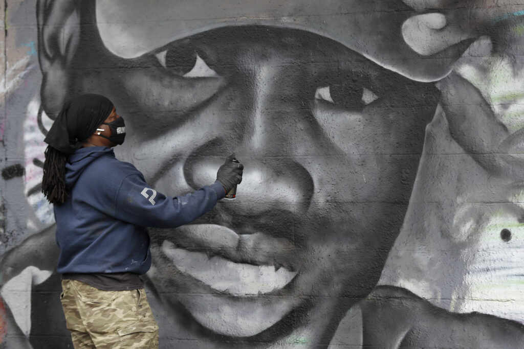 Ahmaud Arbery, Theo Ponchaveli Artist Theo Ponchaveli paints a mural of the likeness of Ahmaud Arbery in Dallas, Friday, May 8, 2020. (AP Photo/Tony Gutierrez)
