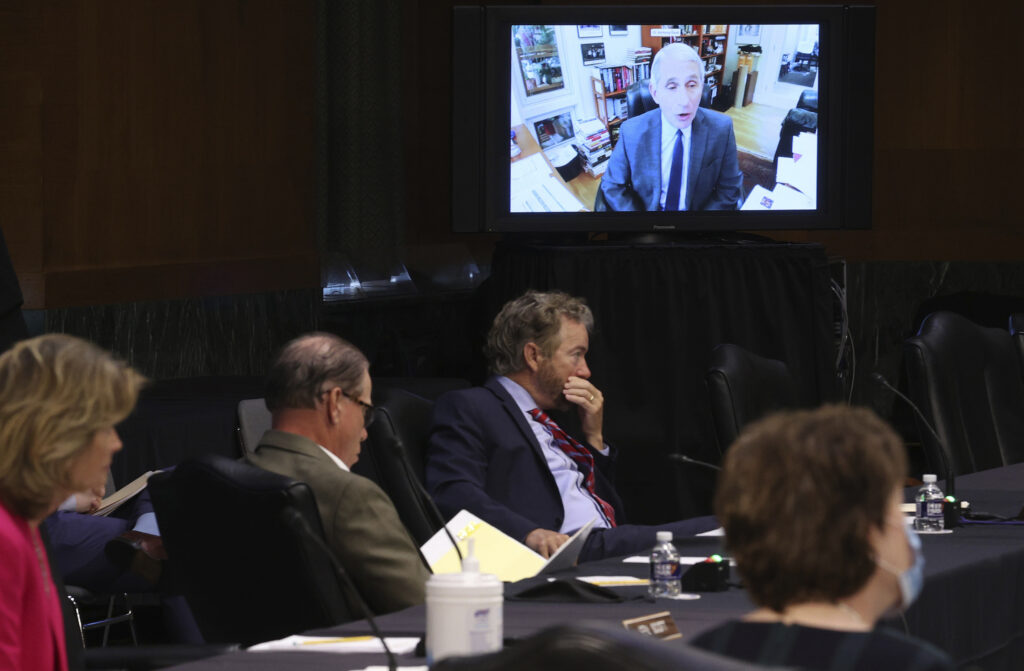 Virus Outbreak Fauci Senators listen as Dr. Anthony Fauci, director of the National Institute of Allergy and Infectious Diseases, speaks remotely during a virtual Senate Committee for Health, Education, Labor, and Pensions hearing.