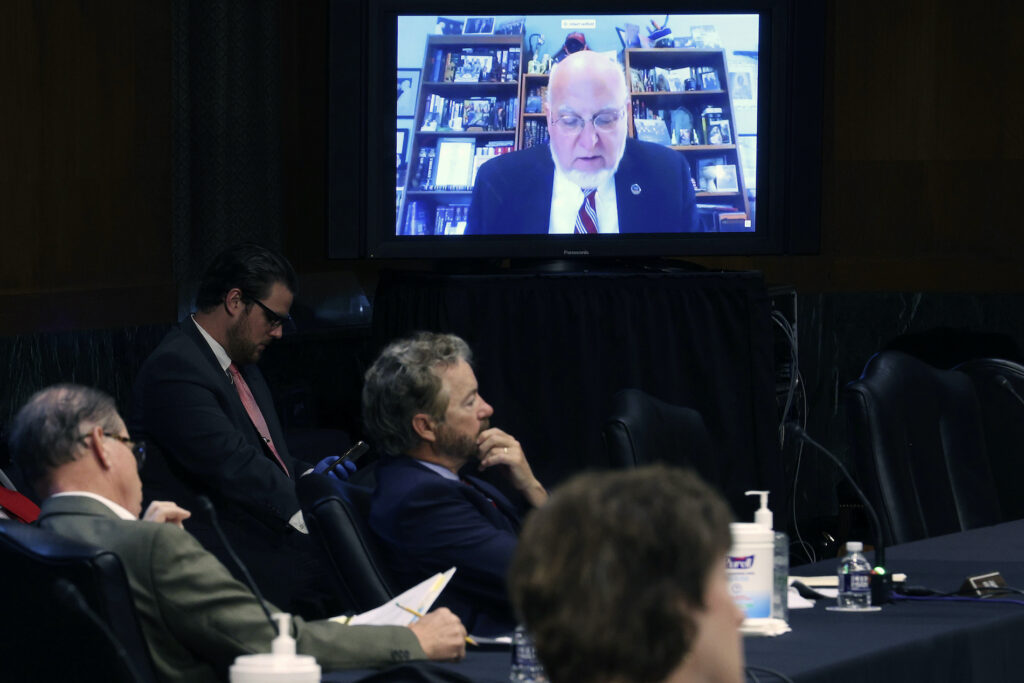Virus Outbreak Fauci Senators and staff listen to Dr. Robert Redfield director of the Centers for Disease Control and Prevention speak remotely during a Senate Health, Education, Labor and Pensions Committee hearing on Capitol Hill on May 12, 2020 in Washington, DC. (Win McNamee/Pool via AP)