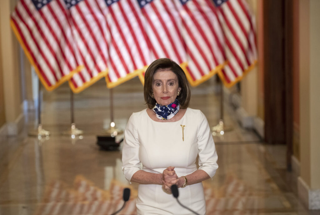 Virus Outbreak Congress House Speaker Nancy Pelosi of Calif., walks to speak about the so-called Heroes Act, Tuesday, May 12, 2020 on Capitol Hill in Washington. Pelosi unveiled a more than $3 trillion coronavirus aid package Tuesday, providing nearly $1 trillion for states and cities, “hazard pay” for essential workers and a new round of cash payments to individuals. (Saul Loeb/Pool via AP)