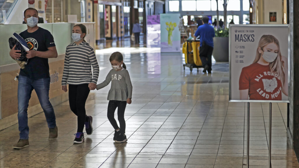 Virus Outbreak Ohio Reopens Shoppers walks past a sign encouraging masks at SouthPark Mall, Wednesday, May 13, 2020, in Strongsville, Ohio. (AP Photo/Tony Dejak)