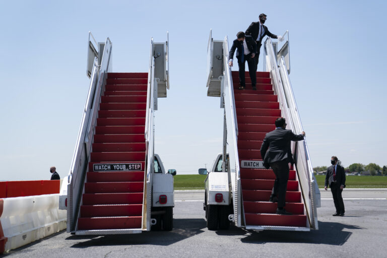 Members of the White House Military Office clean the stair for Air Force One ahead of the arrival of President Donald Trump for a tour of Owens & Minor Inc., a medical supply company, Thursday, May 14, 2020, in Allentown, Pa. (AP Photo/Evan Vucci)