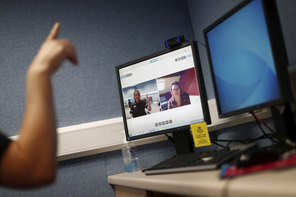 Virus Outbreak Britain Professionals are turning to Zoom to carry out work typically done in person. (Hannah McKay/Pool Photo via AP)
