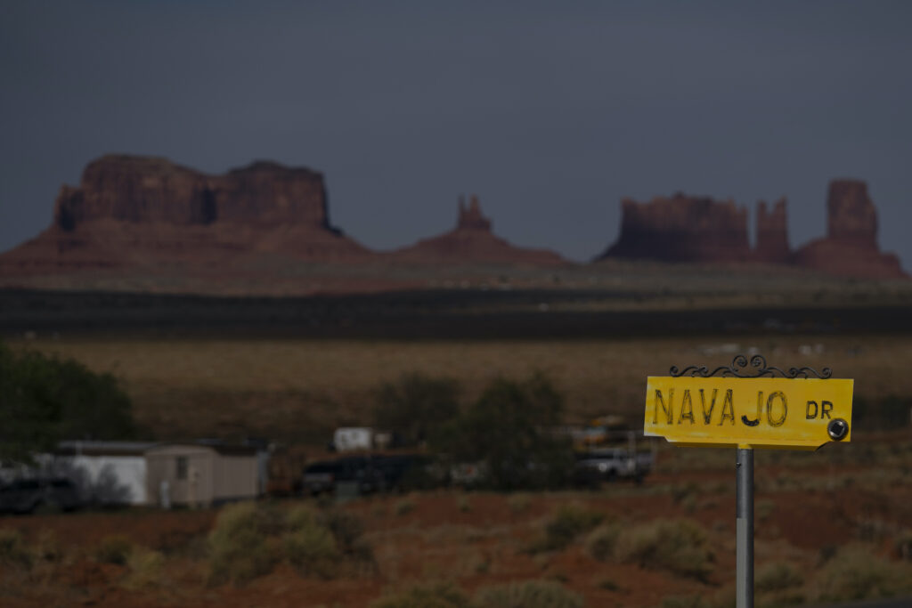 2020 Census Rural Worries In this April 30, 2020, photo, a sign marks Navajo Drive as Sentinel Mesa, homes and other structures in Oljato-Monument Valley, Utah on the Navajo Reservation, stand in the distance. (AP Photo/Carolyn Kaster)