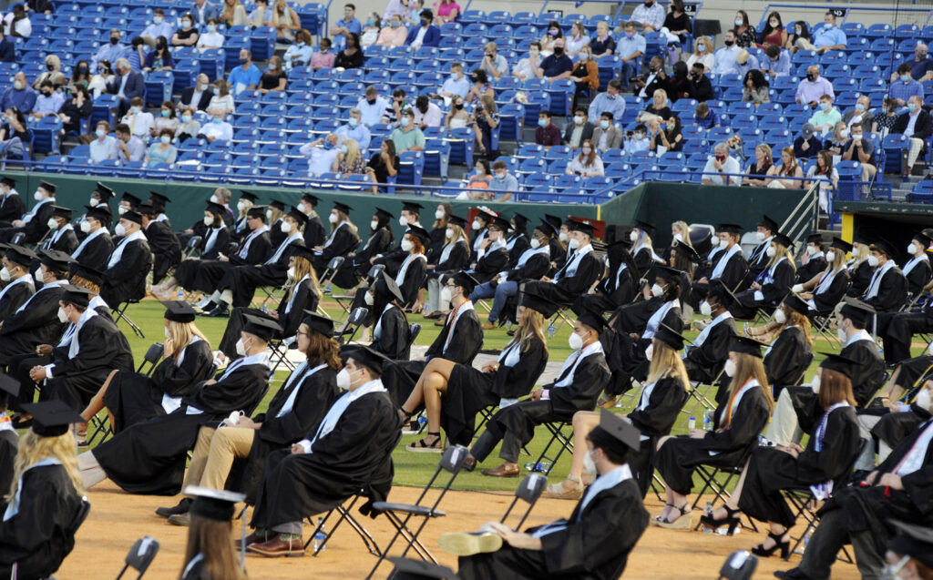 Virus Outbreak Graduation Alabama Senior class members and spectators, most of them wearing masks, attend the graduation ceremony of Spain Park High School in Hoover, Ala., Wednesday, May 20, 2020. Health officials say usual graduation ceremonies could endanger the public health by promoting the spread of disease. But school officials say they're using social distancing guidelines and abiding by state health rules. (AP Photo/Jay Reeves)