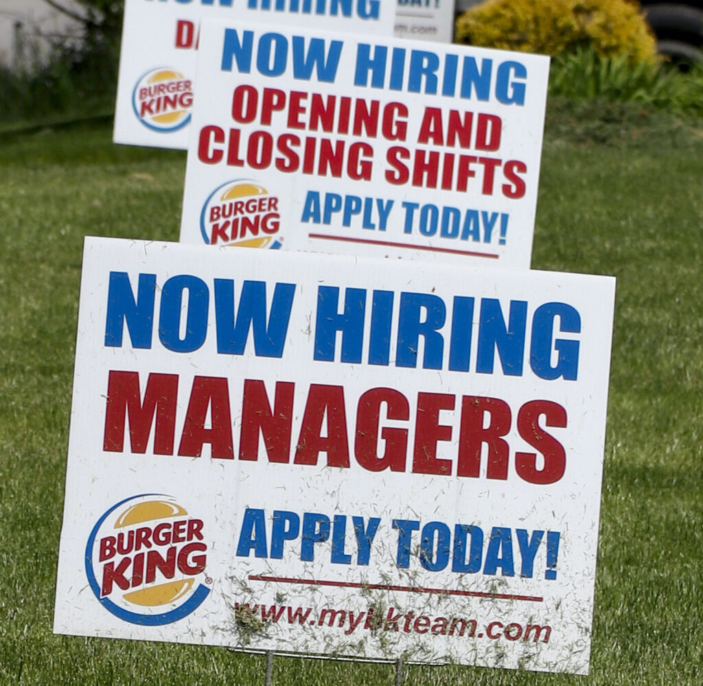 Virus Outbreak Pennsylvania Unemployment A row of signs advertising jobs are posted in front of a Burger King restaurant, Thursday, May 21, 2020, in Harmony, Pa. (AP Photo/Keith Srakocic)