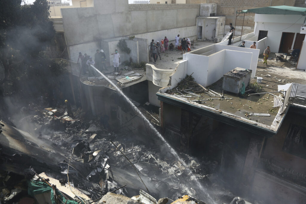 Pakistan Plane Crash Fire brigade staff try to put out fire caused by plane crash in Karachi, Pakistan, Friday, May 22, 2020. (AP Photo/Fareed Khan)
