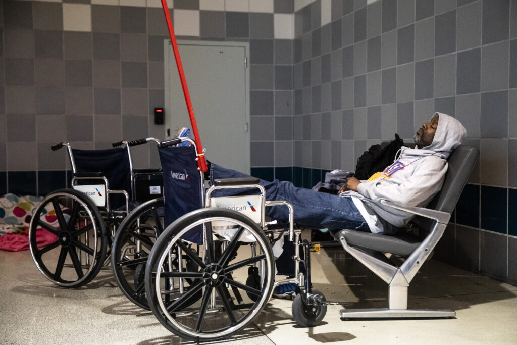 Virus Outbreak Pennsylvania Airport Homeless A homeless person sleeps at Philadelphia International Airport in Philadelphia, Monday, May 25, 2020. (AP Photo/Matt Rourke)