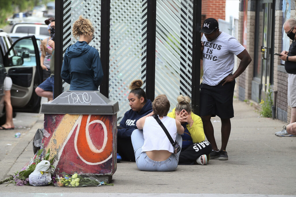 Minnneapolis Police Death Mourners gather around a makeshift memorial, Tuesday, May 26, 2020 in Minneapolis, near where an black man was taken into police custody the day before who later died. (AP Photo/Jim Mone)
