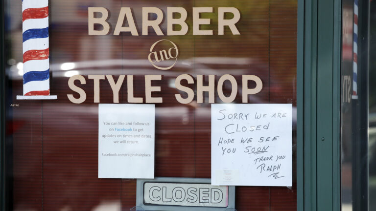 A Seattle barber shop remains closed because of the coronavirus outbreak on May 19. Last week, an additional 2.1 million people filed for unemployment benefits around the country.