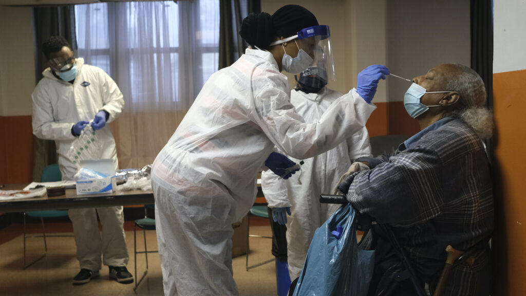 Mary Mack, right, a resident of senior housing, is tested for COVID-19 in Paterson
