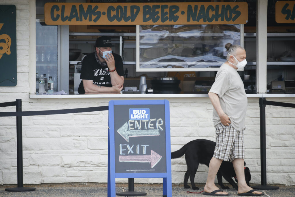 Virus Outbreak New Jersey Customer wears face mask in Belmar, N.J.