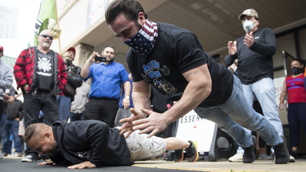 Virus Outbreak-Defiant Gym Atilis Gym co-owner Ian Smith does pushups outside the storefront in Bellmawr.