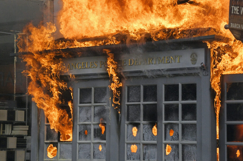 A Los Angeles Police Department kiosk is seen ablaze in The Grove shopping center during a protest over the death of George Floyd