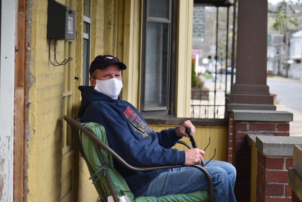 Scott Hoffman sits on his porch in Sunbury, Northumberland County, on April 29, 2020. (Ed Mahon / PA Post)