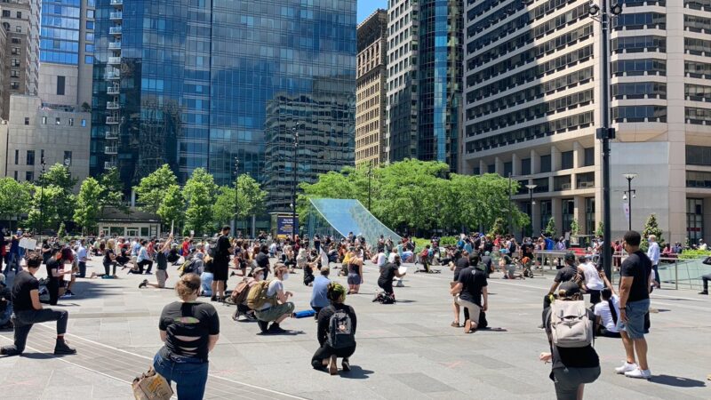 Protesters at City Hall in Philadelphia take a knee in a show of support for victims of police violence. (Zachariah Hughes/WHYY)