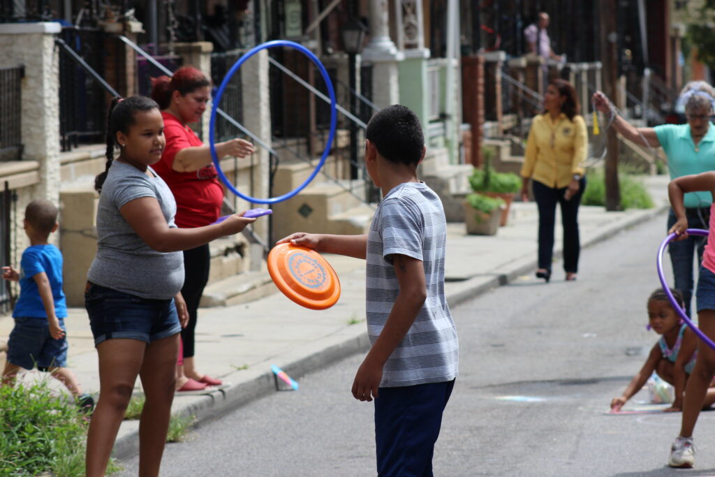 Families play on a North Philadelphia Playstreet in a 2018 photo (Philadelphia Parks and Rec) Families play on a North Philadelphia Playstreet in a 2018 photo. (Courtesy of the City of Philadelphia)