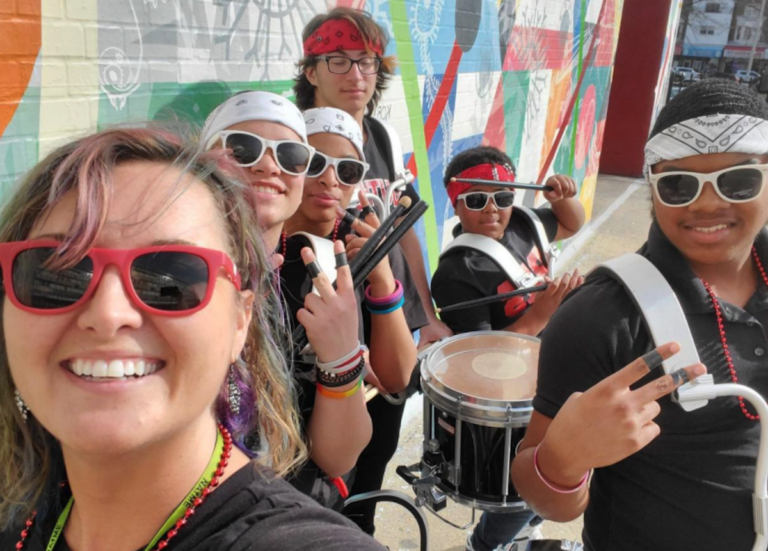 South Philadelphia High School music director Courtney Powers, left, with her students outside the school building earlier this school year. (Courtesy of Courtney Powers)