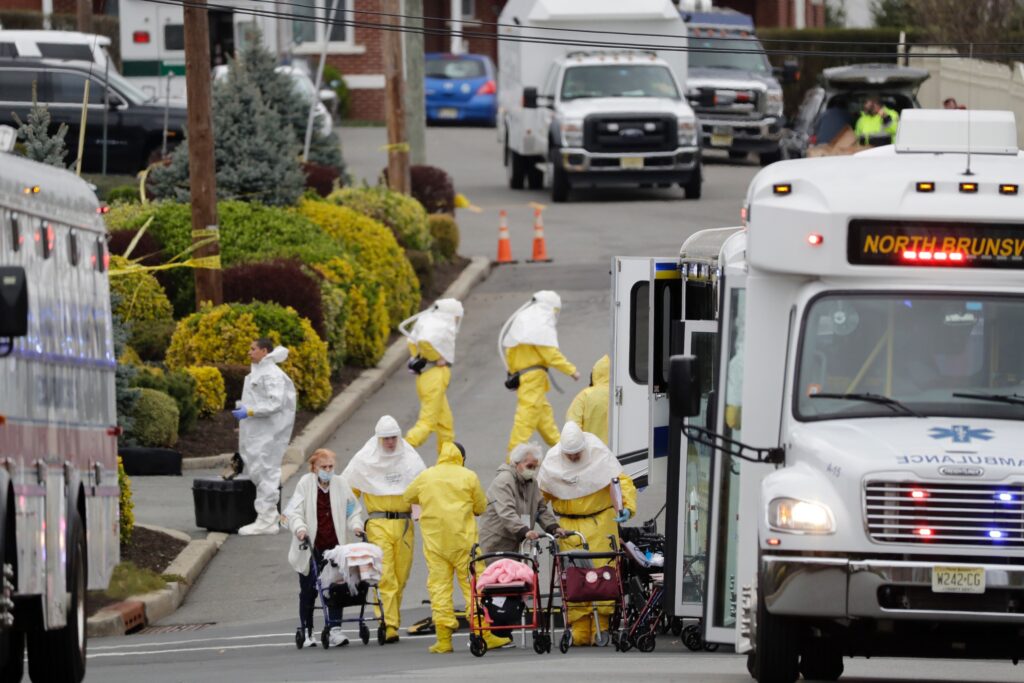 Virus Outbreak New Jersey Residents from St. Joseph's Senior Home are helped on to buses in Woodbridge, N.J., Wednesday, March 25, 2020. (AP Photo/Seth Wenig)