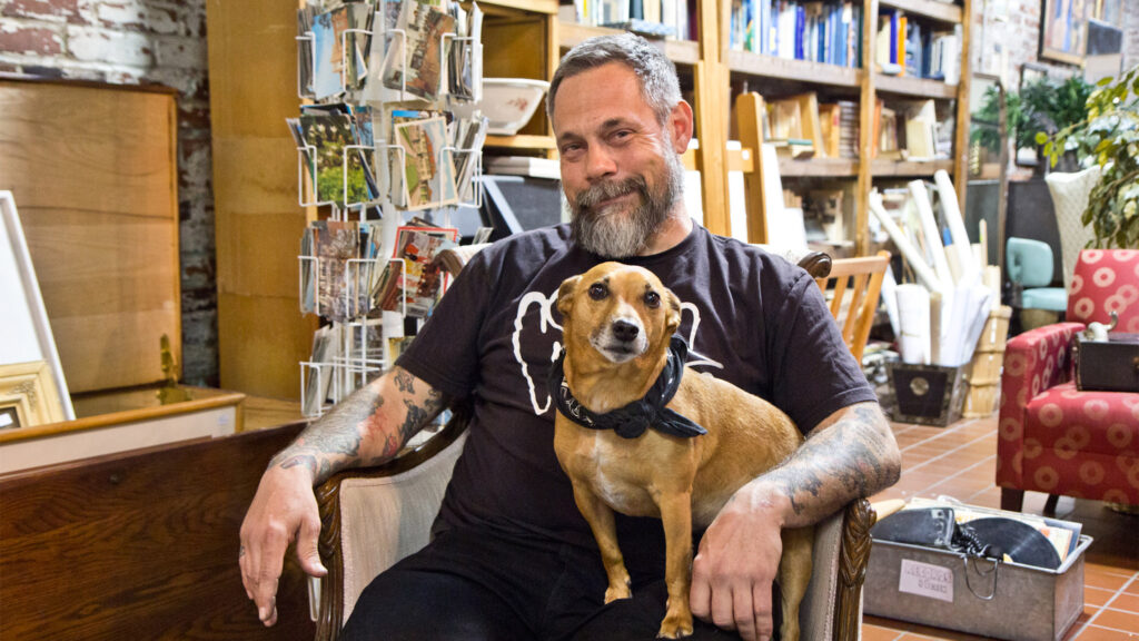 antiqueshops-jinxed-kpaynter-crop Mike 'Supermodel,' the owner of Jinxed stores, with his dog Ronnie. (Kimberly Paynter/WHYY)