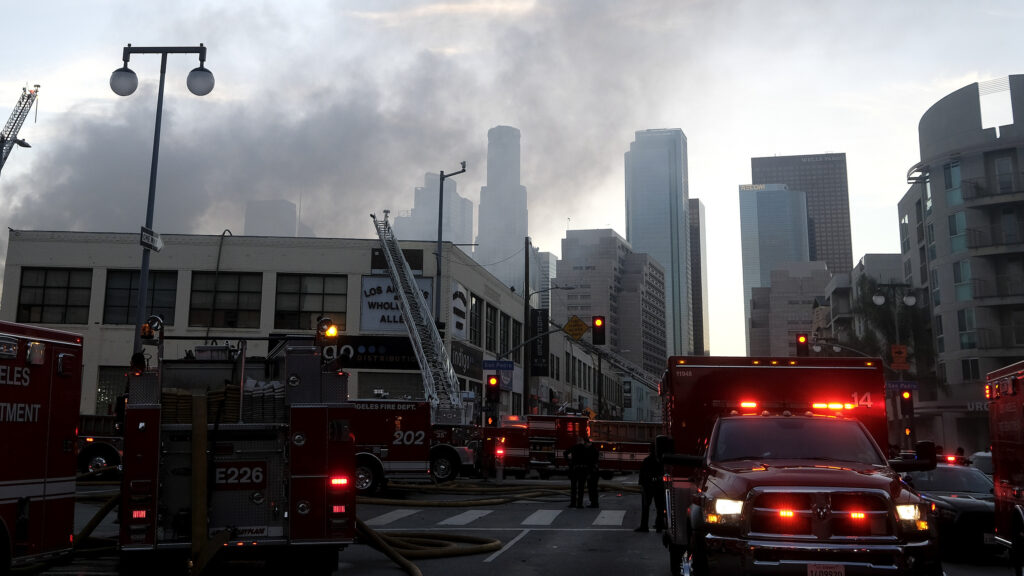 Smoke rises from the scene of a fire and explosion in Los Angeles on Saturday that injured 11 firefighters. Smoke rises from the scene of a fire and explosion in Los Angeles on Saturday that injured 11 firefighters.