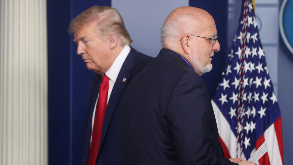 President Trump’s administration “is obsessed with magic bullets — vaccines, new medicines, or a hope that the virus will simply disappear,” The Lancet says. Trump and CDC Director Robert Redfield attended a coronavirus task force briefing at the White House last month. President Trump's administration