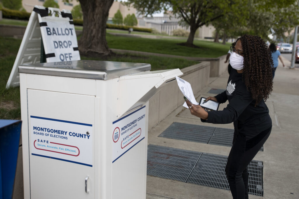 An Ohio voter drops off her ballot at the Board of Elections in Dayton, Ohio on April 28, 2020. Legal fights around mail-in voting are heating up as states turn to it amid the coronavirus pandemic. An Ohio voter drops off her ballot at the Board of Elections in Dayton, Ohio on April 28, 2020. Legal fights around mail-in voting are heating up as states turn to it amid the coronavirus pandemic. (Megan Jelinger/AFP via Getty Images)